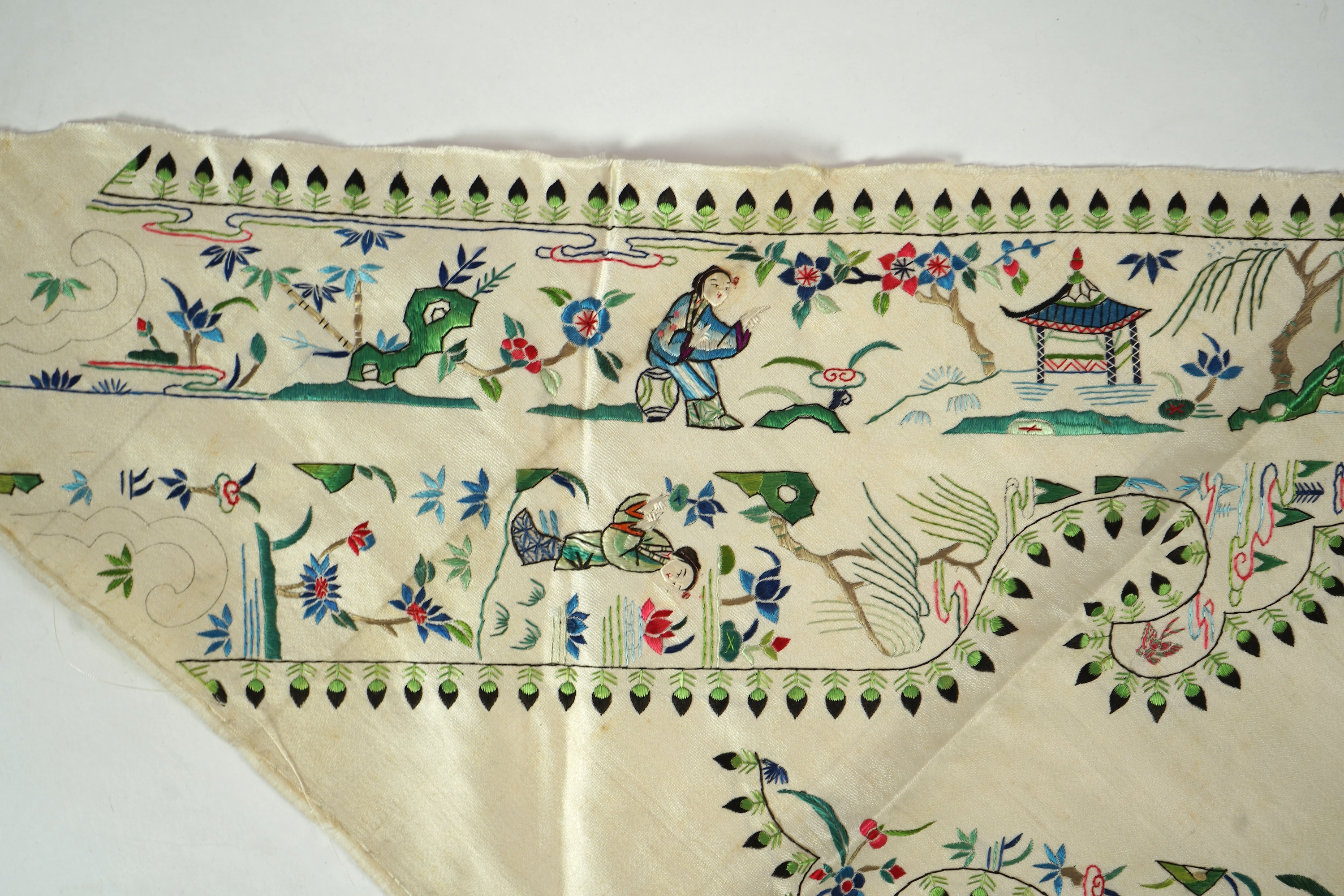 A Chinese embroidered silk panel of uncut robe borders, eleven similar sleeve panels and two other items, late Qing dynasty